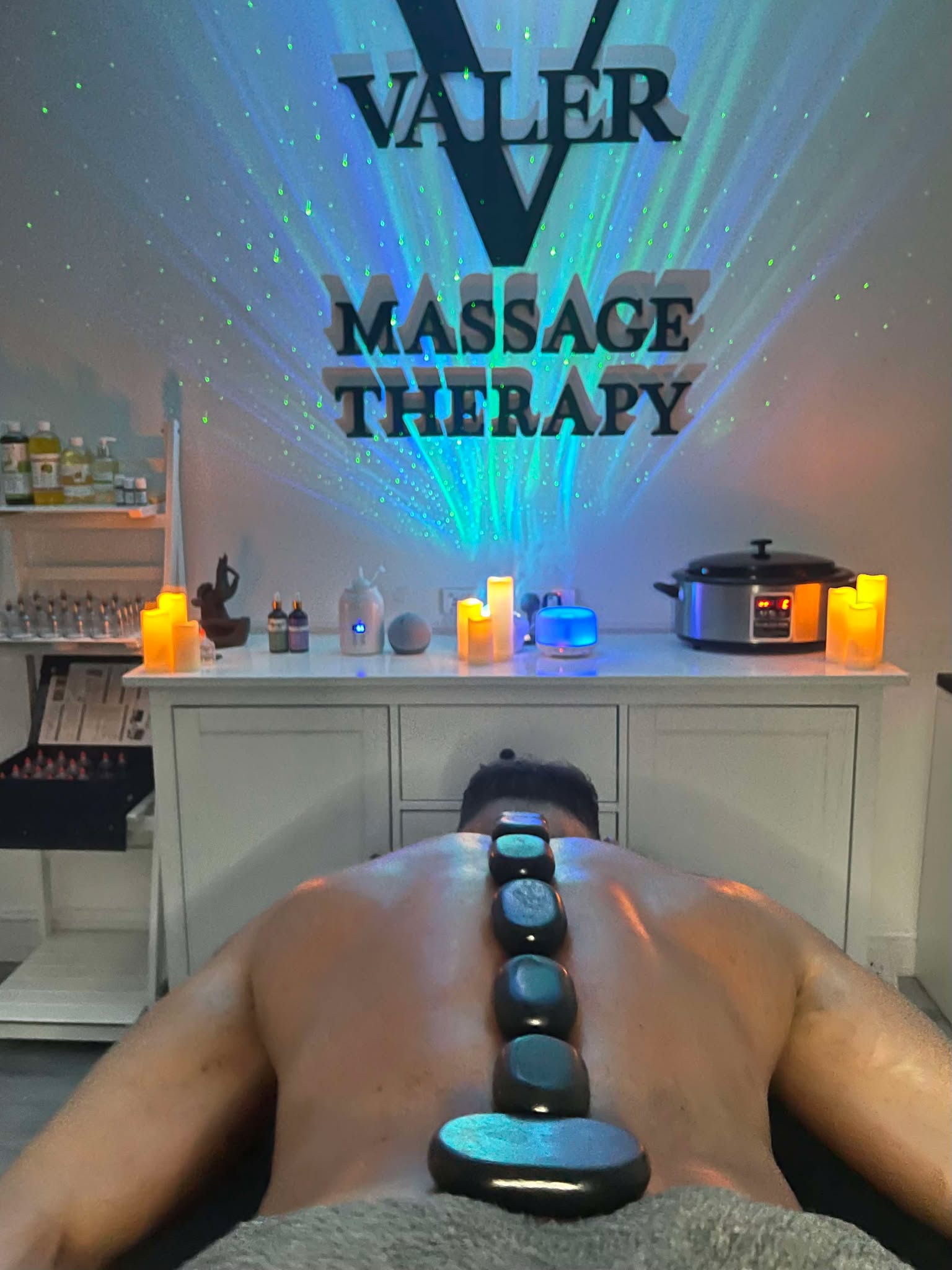 Hot stones on mans back