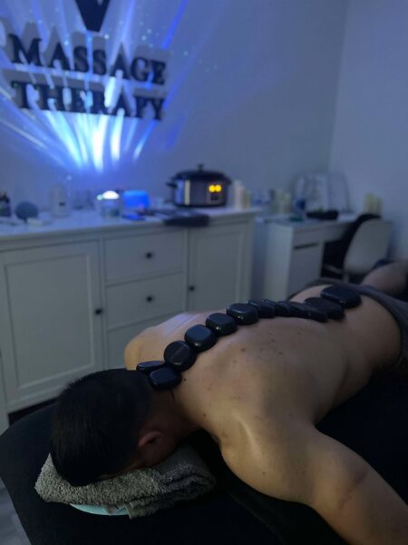 Hot stones on mans back