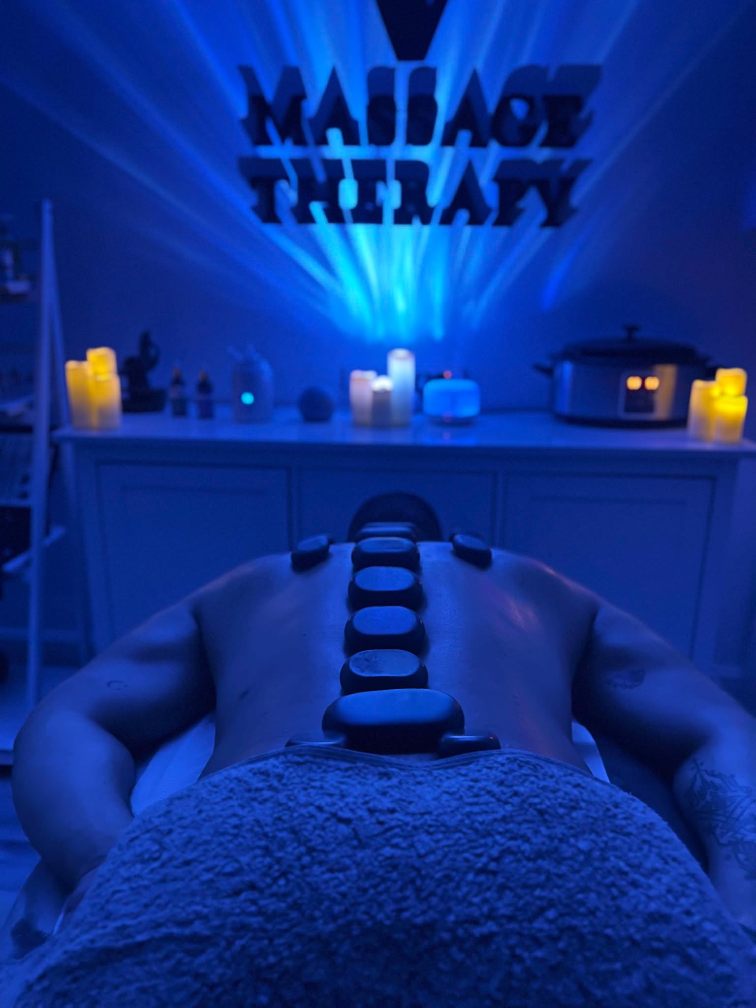 Hot stones on mans back